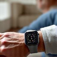 Senior wearing a smartwatch tracking health metrics in a comfortable home setting